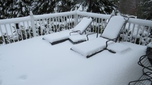snow covered deck and chairs