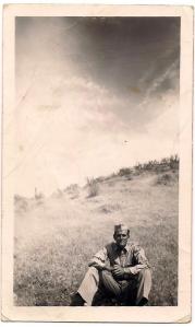 Uncle Dwight sitting in field during war